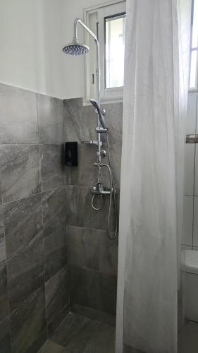 a bathroom with a shower with a shower curtain at Kelinda in Les Abymes