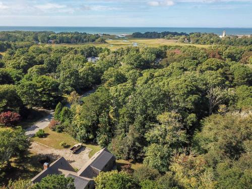 an aerial view of a house with trees and a river at Beach Getaway with Private Backyard in Orleans