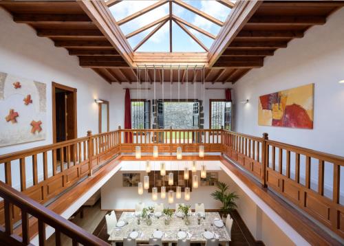a large room with a skylight and a table with candles at Spacious Private Villa up to 16 - Casa Quintero Yaiza - Volcano, Timanfaya park, Bodega & South Beaches - Heated Pool - Game Room - Charcoal grill in Yaiza