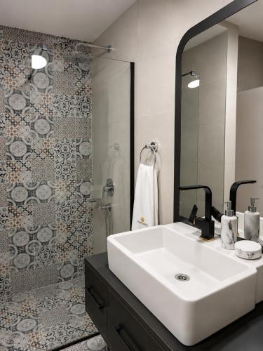 a bathroom with a white sink and a shower at 101 Apartments in Igalo