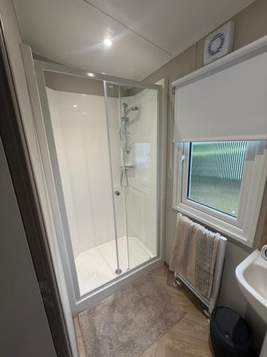a bathroom with a shower and a sink at The Elms Escape in Porthcawl