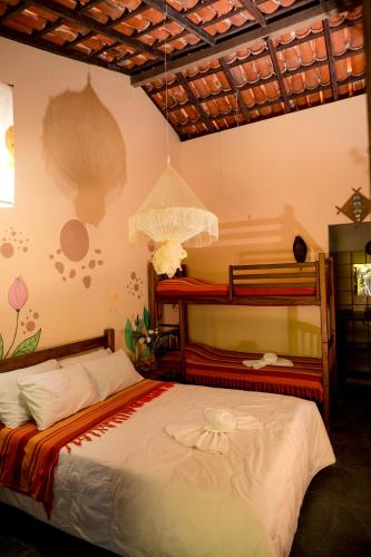 a bedroom with a bed and a bunk bed at Pousada Templo Aláfia in Vera Cruz de Itaparica