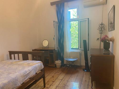 a bedroom with a bed and a window at Mytilini Townhouse in Mytilene