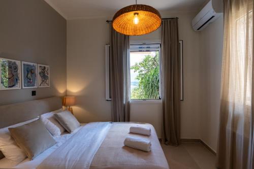 a bedroom with a large bed and a window at Art and Light in Argostoli