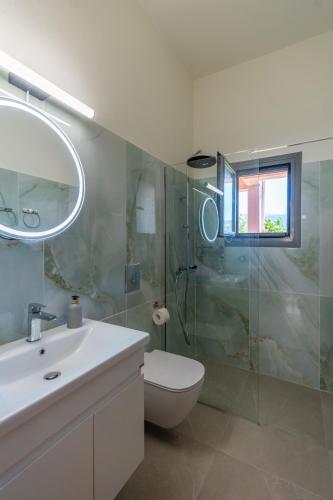a bathroom with a toilet and a sink and a shower at Art and Light in Argostoli