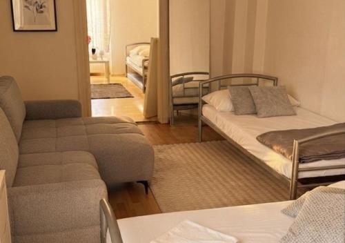 a living room with a couch and a bed and a living room at Harzer Domschatz-Auszeit Monteure - Einzelbetten in Halberstadt