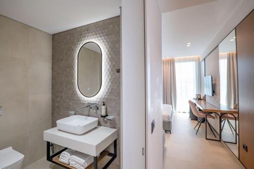 a bathroom with a sink and a mirror at Colosseum Hotel in Ksamil
