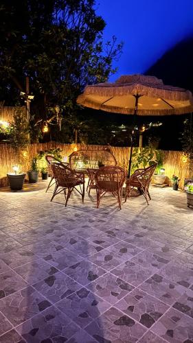 a group of chairs and an umbrella on a patio at maderedocevida in Boaventura