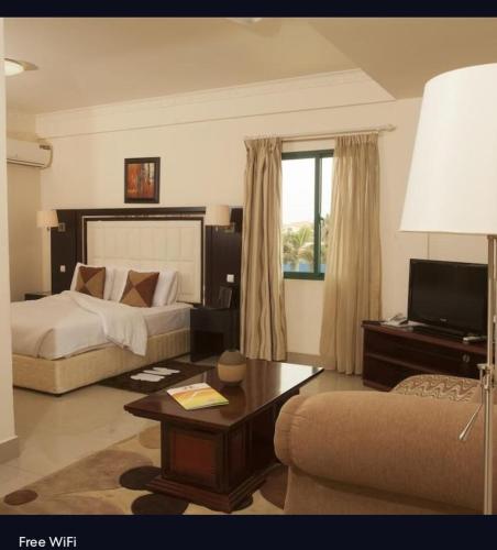 a living room with a bed and a couch at Agentour Guesthouses in Luanda