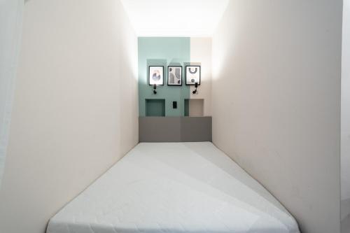 a room with a white bed in a white room at Arthur's Home in Miskolc