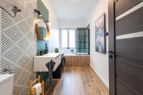 a bathroom with a sink and a mirror at Arthur's Home in Miskolc