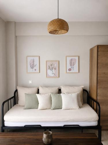 a bed with white pillows in a room at Friends' Place Trikala in Tríkala