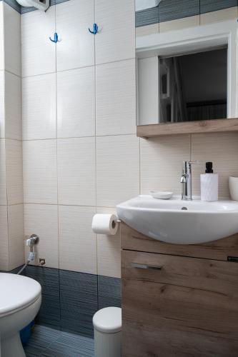 a bathroom with a sink and a toilet at Blue Horizon luxury residence in Kanali