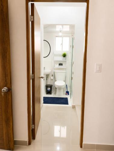 an open door to a bathroom with a toilet at Tropical Pearl Getaway in Los Paredones