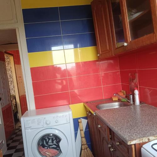 a kitchen with a washing machine and a sink at Квартира in Sumy