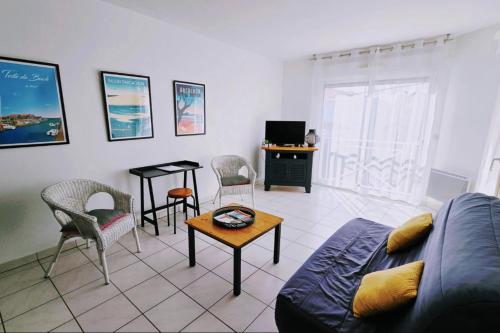 a living room with a couch and chairs and a table at Spacious apartment in La Teste-de-Buch in La Teste-de-Buch