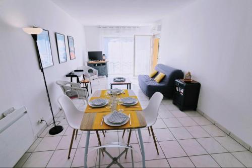 a living room with a table and a couch at Spacious apartment in La Teste-de-Buch in La Teste-de-Buch