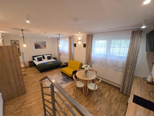 a living room with a yellow couch and a table at Zatoka Apartamenty in Władysławowo