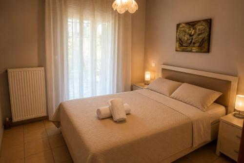 a bedroom with a bed with two towels on it at Vasw Apartment in Ágios Nikólaos