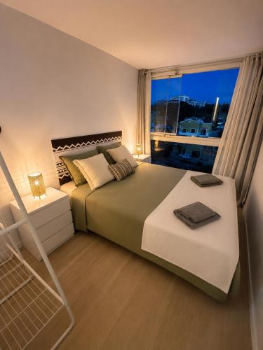 a bedroom with a large bed and a window at Luz y calma junto al mar in Lagos