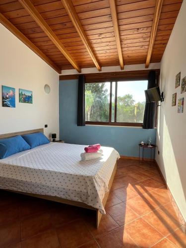 a bedroom with a bed and a wooden ceiling at Villa Alelida in Cinisi