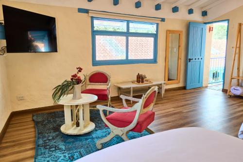 a living room with two chairs and a table at Casa Provenzal Hotel Boutique in Villa de Leyva