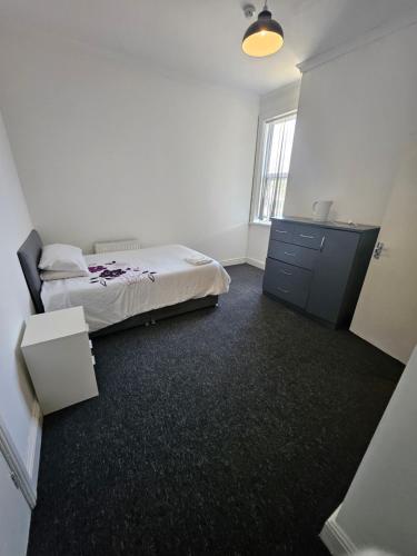 a bedroom with a bed and a dresser in it at Dudley Port in Ocker Hill