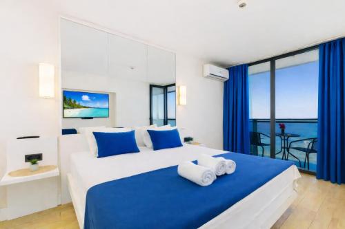a bedroom with two beds with blue and white at Casa Bellamare Batumi in Batumi