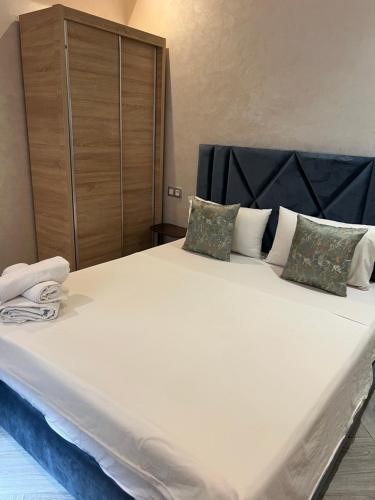 a large white bed with two pillows on it at عروس النخيل in Tétouan