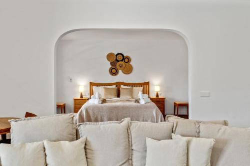 a bedroom with a bed and a couch with pillows at Ca'n Cristofal in Felanitx
