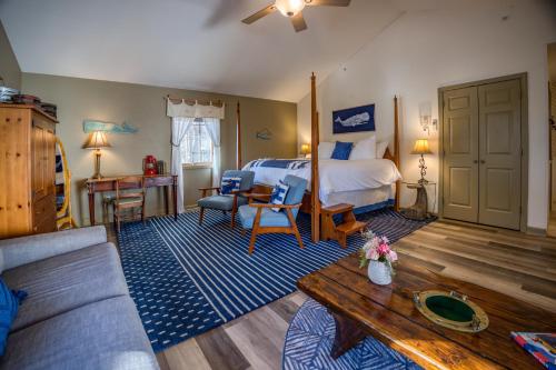 a bedroom with a bed and a living room at The Inn at Stockbridge in Stockbridge