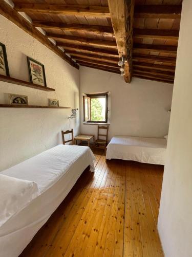 a bedroom with two beds and a window at Casa con Piscina Climatizzata - Vecchia Stalla in Casa Montacuto