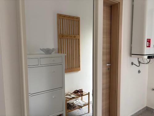 a room with a closet with shoes on a shelf at Apartment 45 in Crikvenica