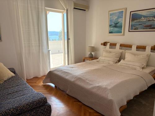 a bedroom with a large bed and a window at Apartment 45 in Crikvenica