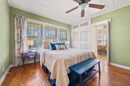 a bedroom with a bed and a ceiling fan at Smallville Farm Retreat in Lake Catherine