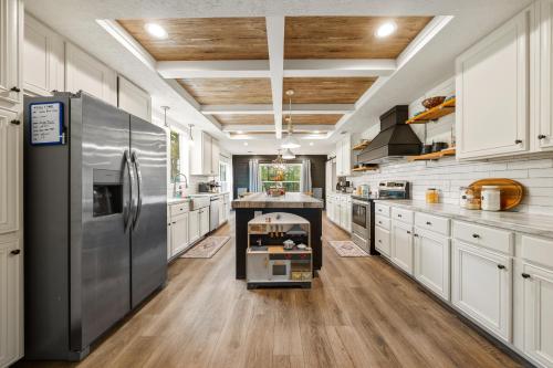a large kitchen with a stainless steel refrigerator at Smallville Farm Retreat in Lake Catherine