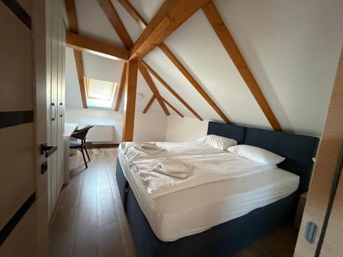 a bedroom with a large bed in a attic at Apartments Memories EV ch 11kW available in Trebinje