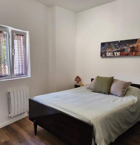 a bedroom with a large bed in a room at Appartement Cévenol in Le Vigan