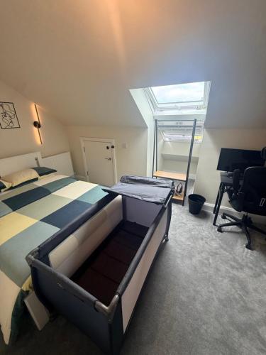 a bedroom with a bed and a desk and a window at Birch view getaway in Dunshaughlin