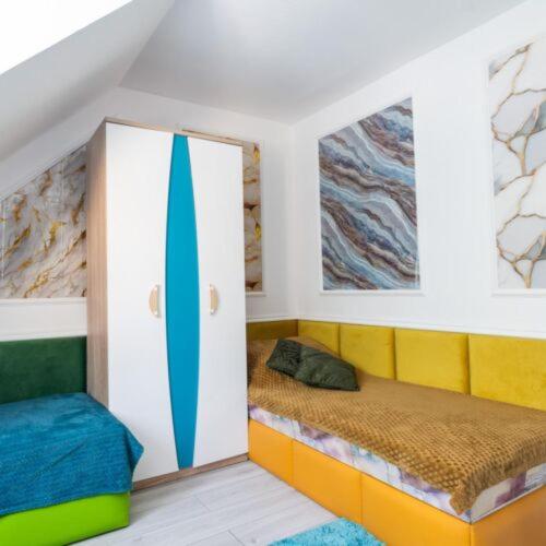 a room with two beds and a surfboard in it at Pensjonat Koral in Kołobrzeg