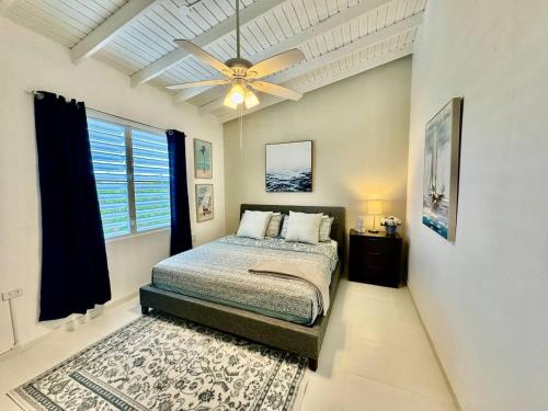 a bedroom with a bed and a ceiling fan at Casa Playa in Boqueron