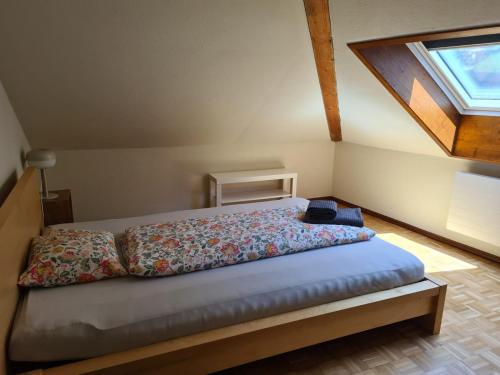 a bed in a room with a window at Ca' di Fant Malvaglia in Malvaglia
