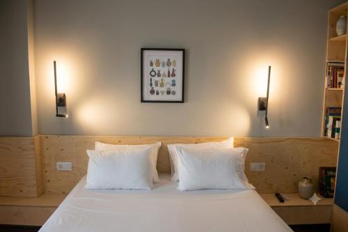 a bedroom with a white bed with two white pillows at BaBu Urban Stay in Katerini