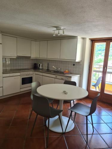 a kitchen with a table and chairs in it at Ca' di Fant Malvaglia in Malvaglia