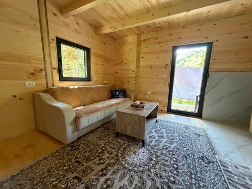 a living room with a couch and a table at Mirsads Mountain Cottage in Plav
