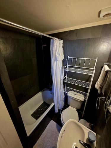 a bathroom with a tub and a toilet and a sink at Hostal Desert in San Pedro de Atacama