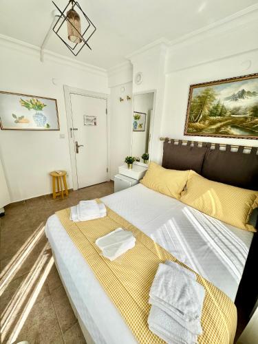 a bedroom with a large bed with towels on it at Hil Ada 1 in Bozcaada
