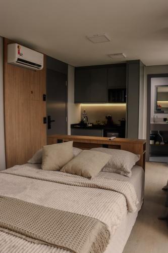 a bedroom with a large bed in a room at TBG Studios in Curitiba