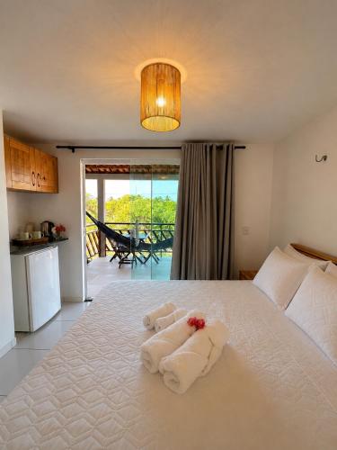 a bedroom with a bed with towels on it at Atins Suites in Atins