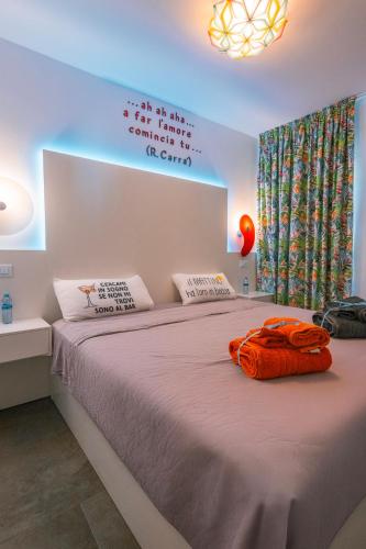 a bedroom with a bed with an orange towel on it at Apartamento Yumbo Iguazu Luxury in Maspalomas